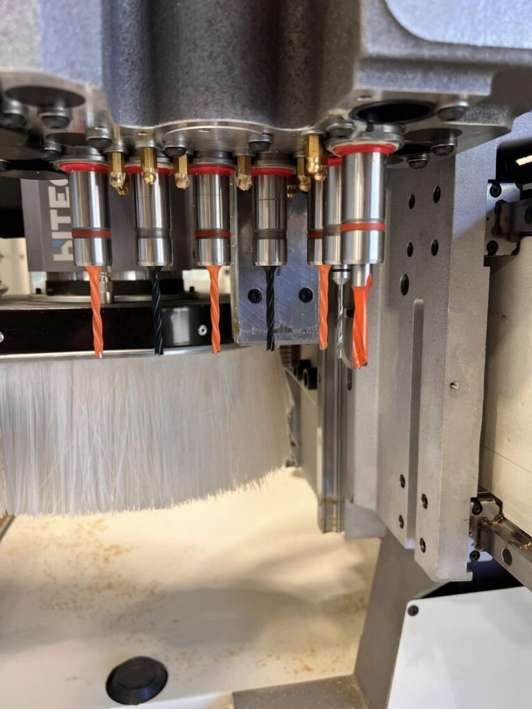 Cabinet door panels being routed on a CNC machine