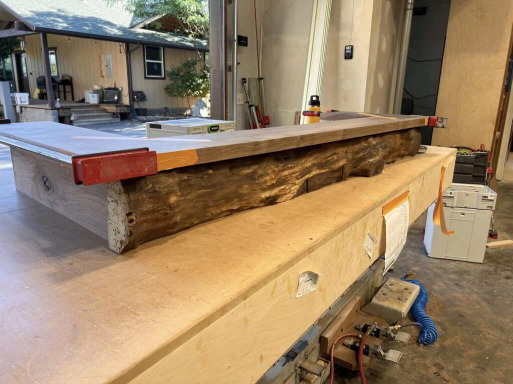 Live-edge wood counter clamped on a workbench during fabrication