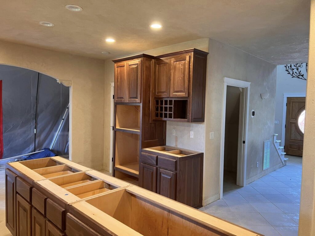 Walnut upper and base cabinetry installed before countertops