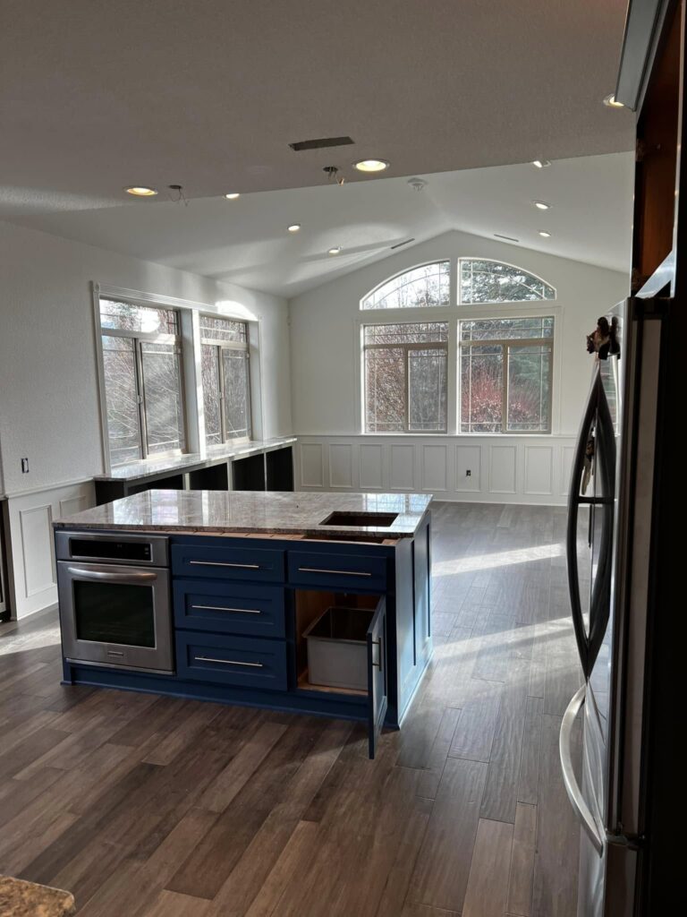 Completed blue-island kitchen viewed from the adjoining room