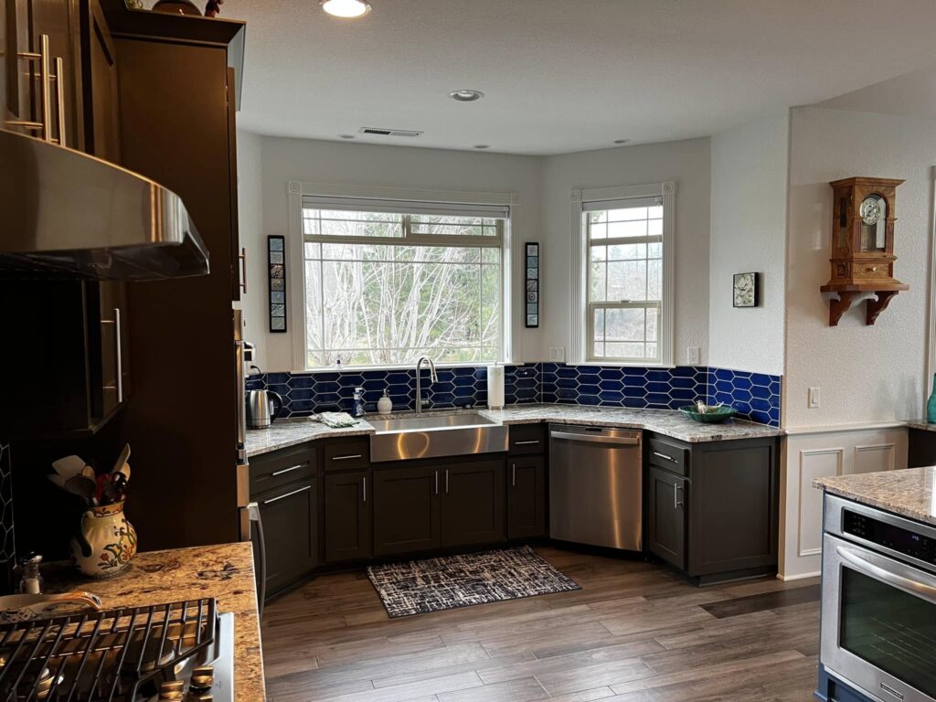 Dark wood kitchen cabinetry surrounding a window and sink