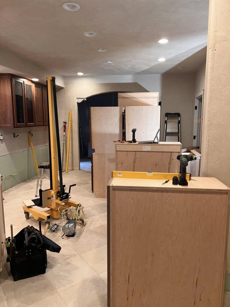 Wide view of walnut cabinetry and island installation