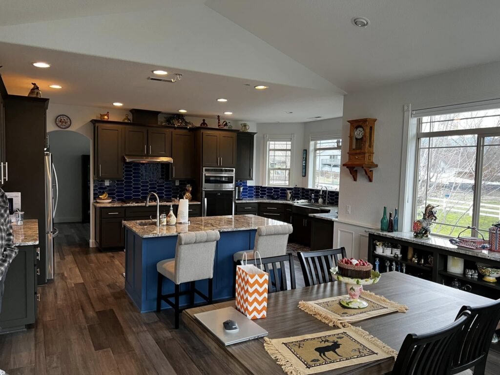 Completed open-plan kitchen and dining area with a blue island