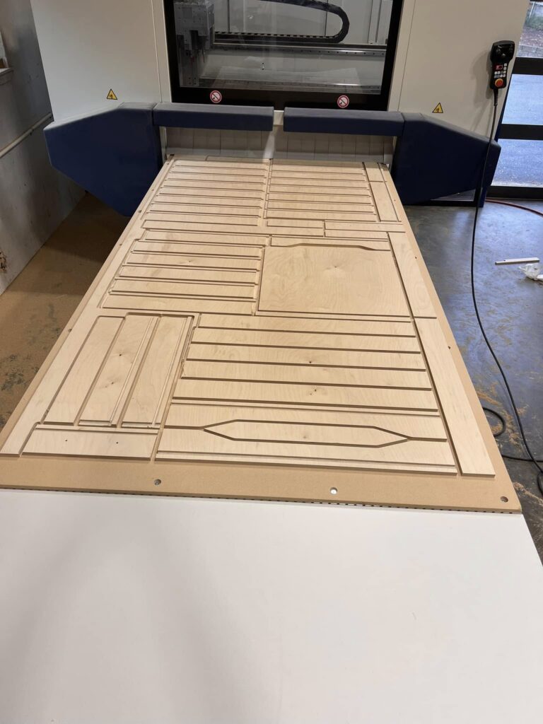 Decorative cabinet panel being cut on a CNC machine
