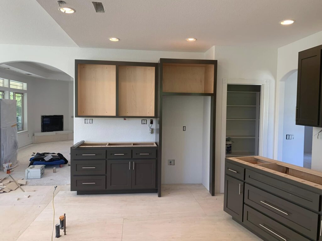 Gray kitchen cabinets installed before counters and appliances