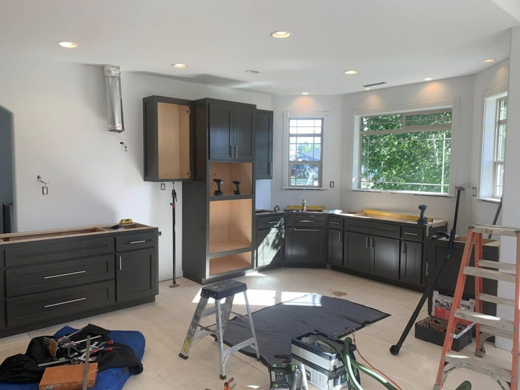 Gray base and wall cabinets during an active installation
