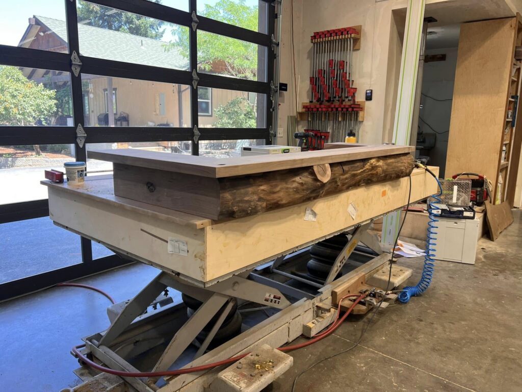 Live-edge counter assembly positioned on a shop lift