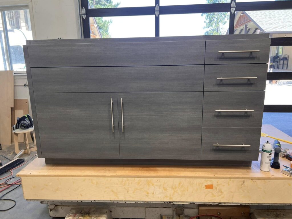 Gray flat-panel sideboard cabinetry photographed in the shop