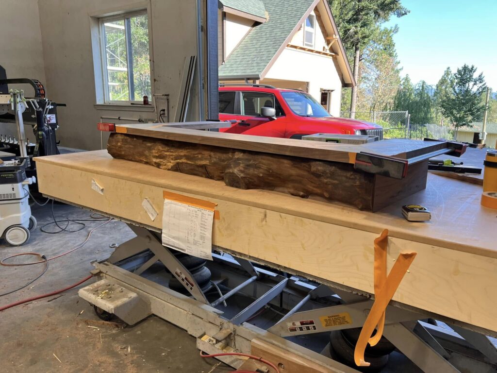 Long live-edge wood counter being assembled in the shop