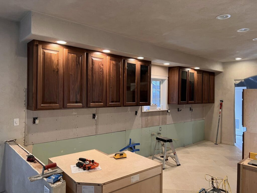 Walnut upper cabinets installed before backsplash and counters