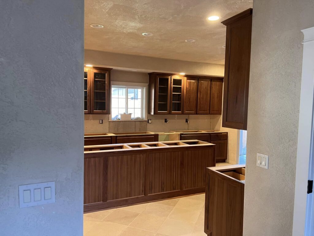 Walnut kitchen installation viewed through a doorway