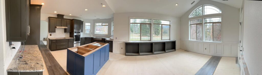 Wide panoramic view of the completed kitchen and adjoining room