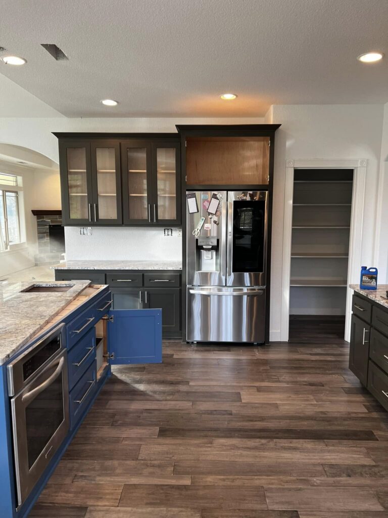 Finished blue-island kitchen viewed toward the refrigerator wall